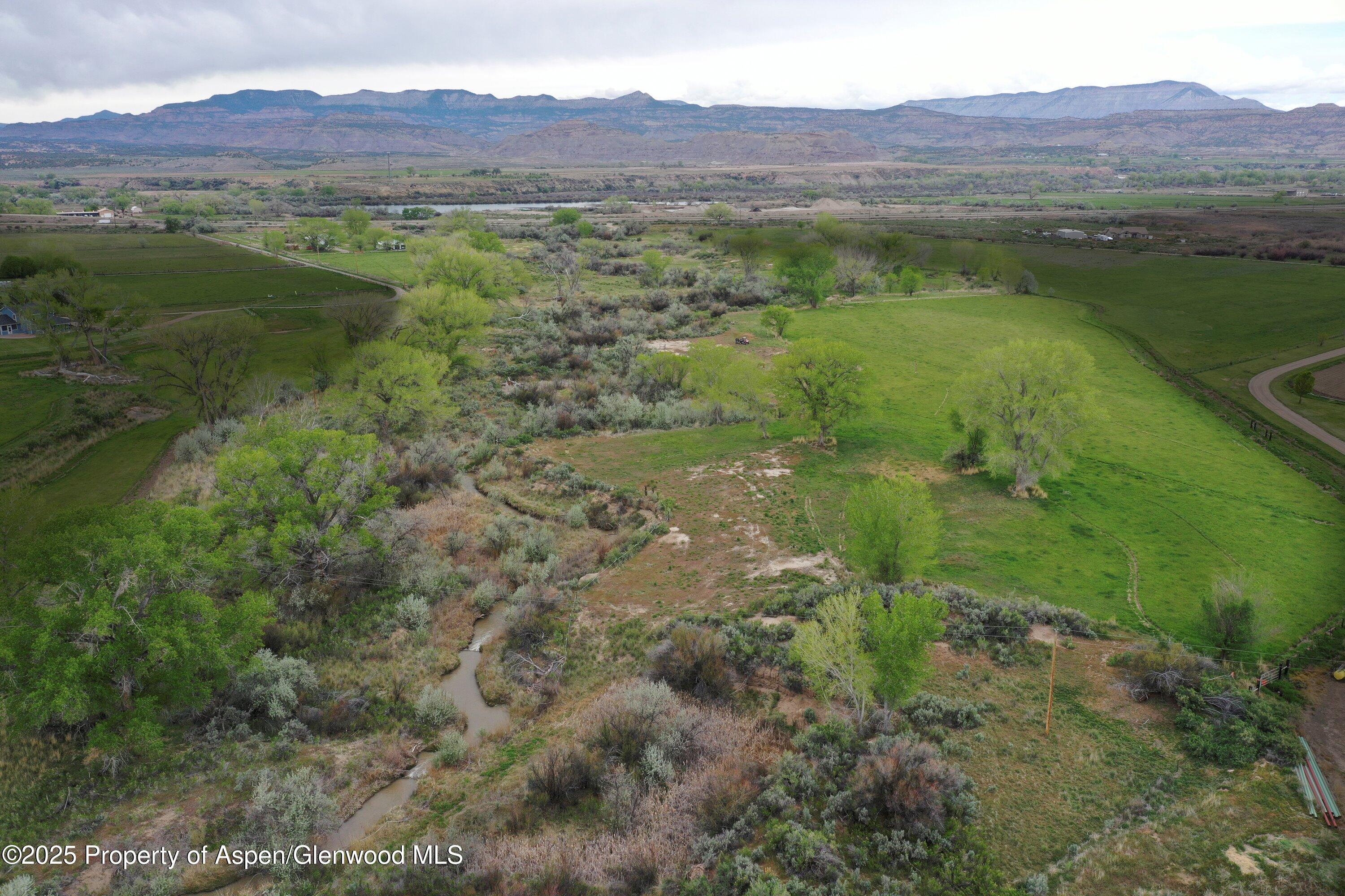 70 Frontage Road De Beque, CO 81630 - Photo 3 of 26 a view of a lush green hillside and a houses with view