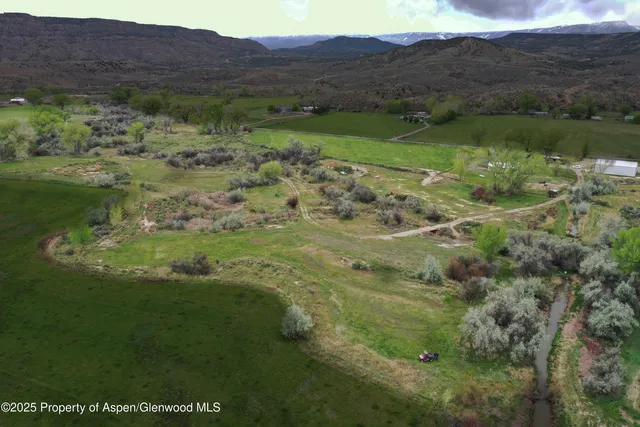 a view of a lush green hillside and houses