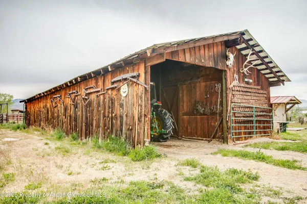 a view of a house with wooden fence