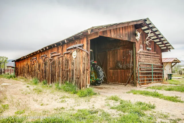a view of a house with wooden fence