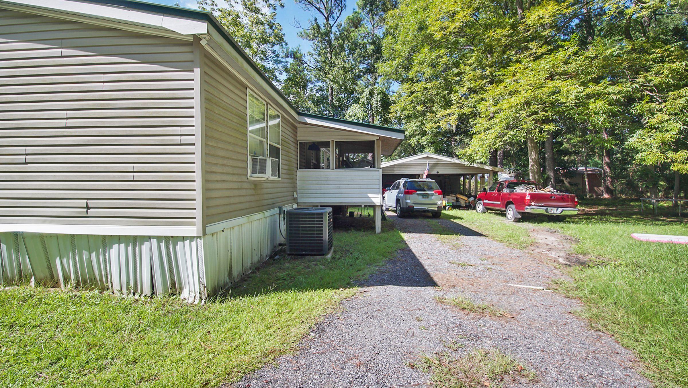 127 Madison Street Freeport, FL 32439 - Photo 2 of 8 a front view of a house with garden