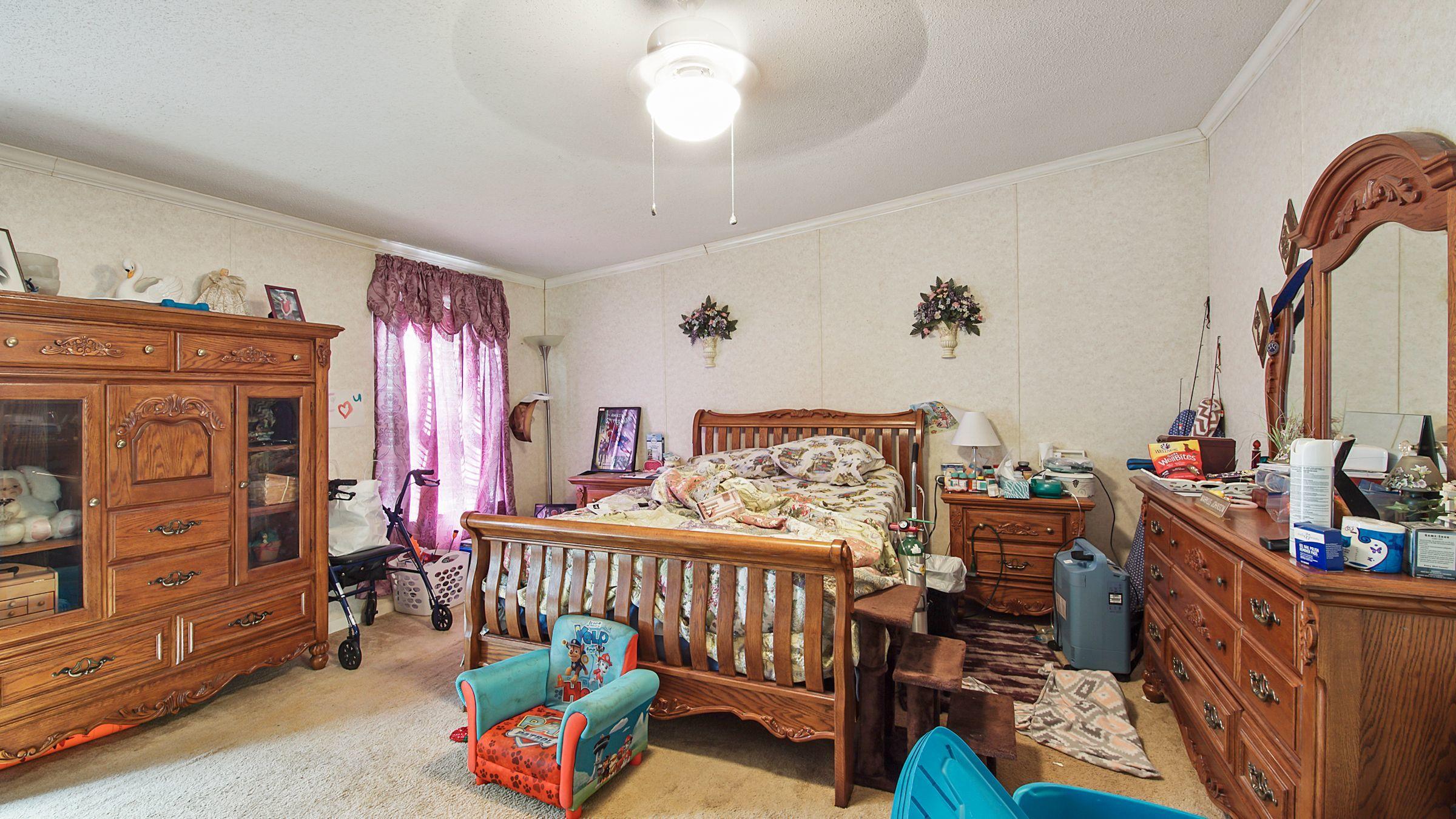 127 Madison Street Freeport, FL 32439 - Photo 6 of 8 a bedroom with furniture and a wooden floor