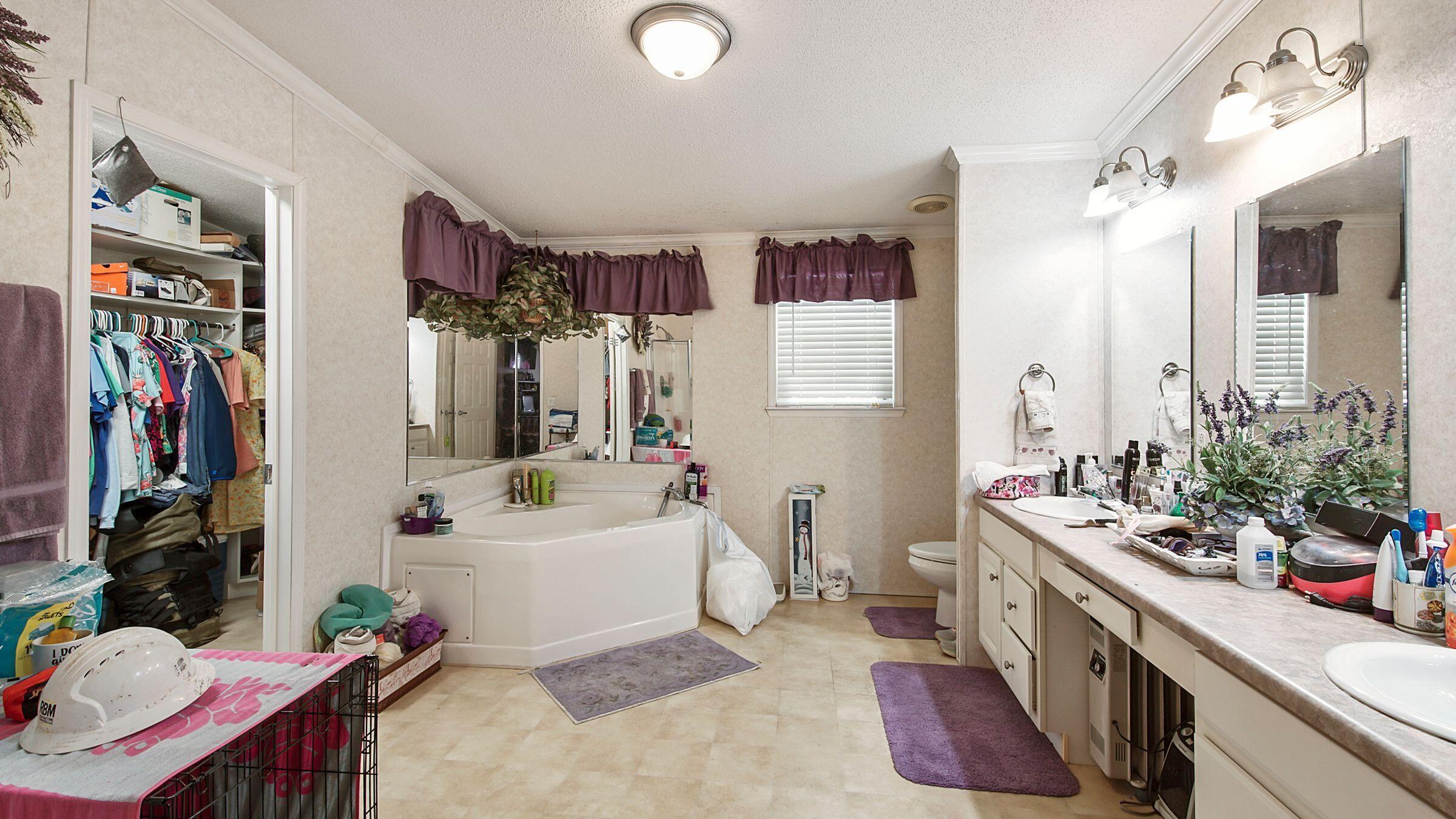 127 Madison Street Freeport, FL 32439 - Photo 7 of 8 a spacious bathroom with a tub sink and mirror