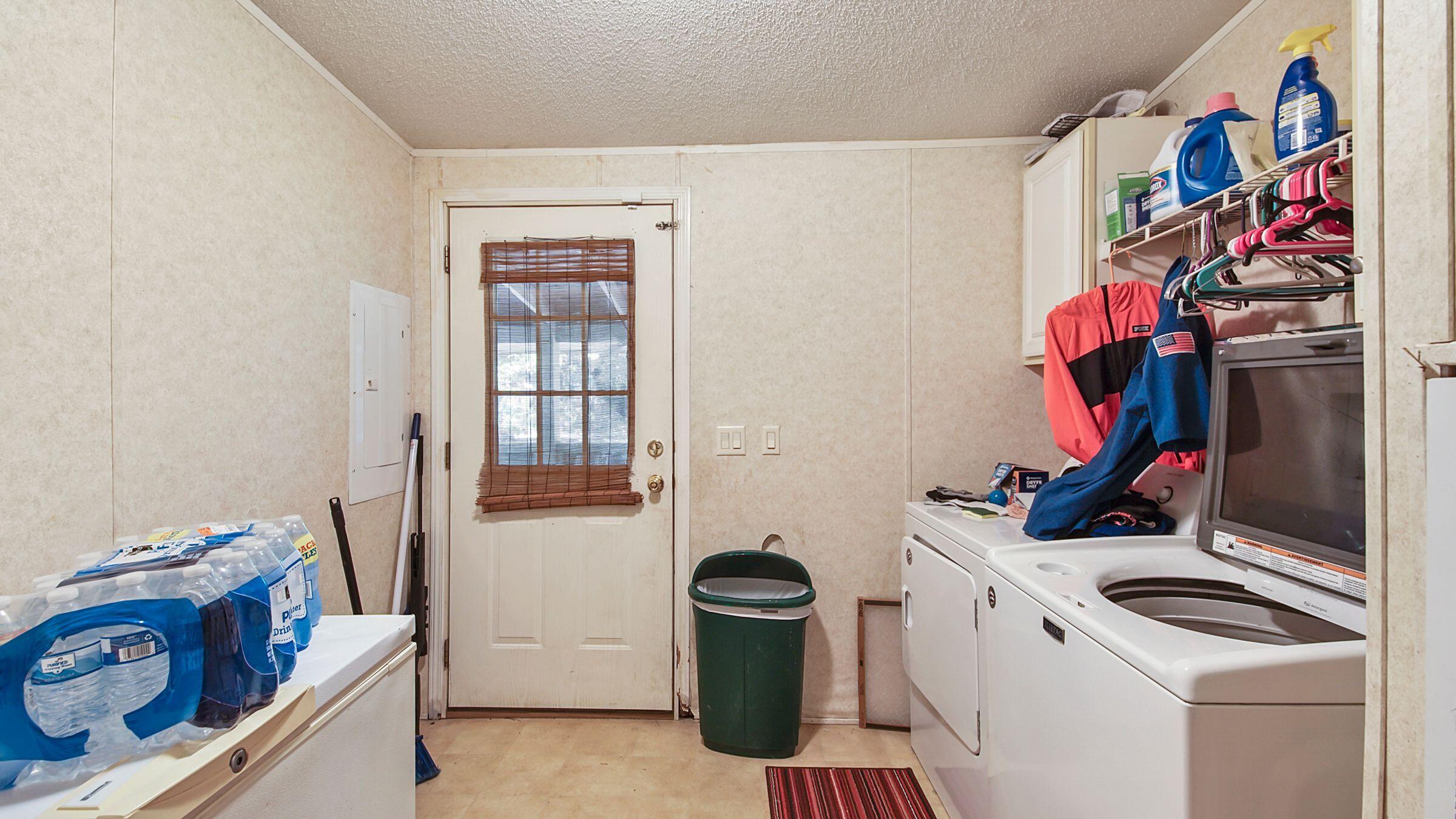 127 Madison Street Freeport, FL 32439 - Photo 8 of 8 a view of walk in closet with clothes and shoes