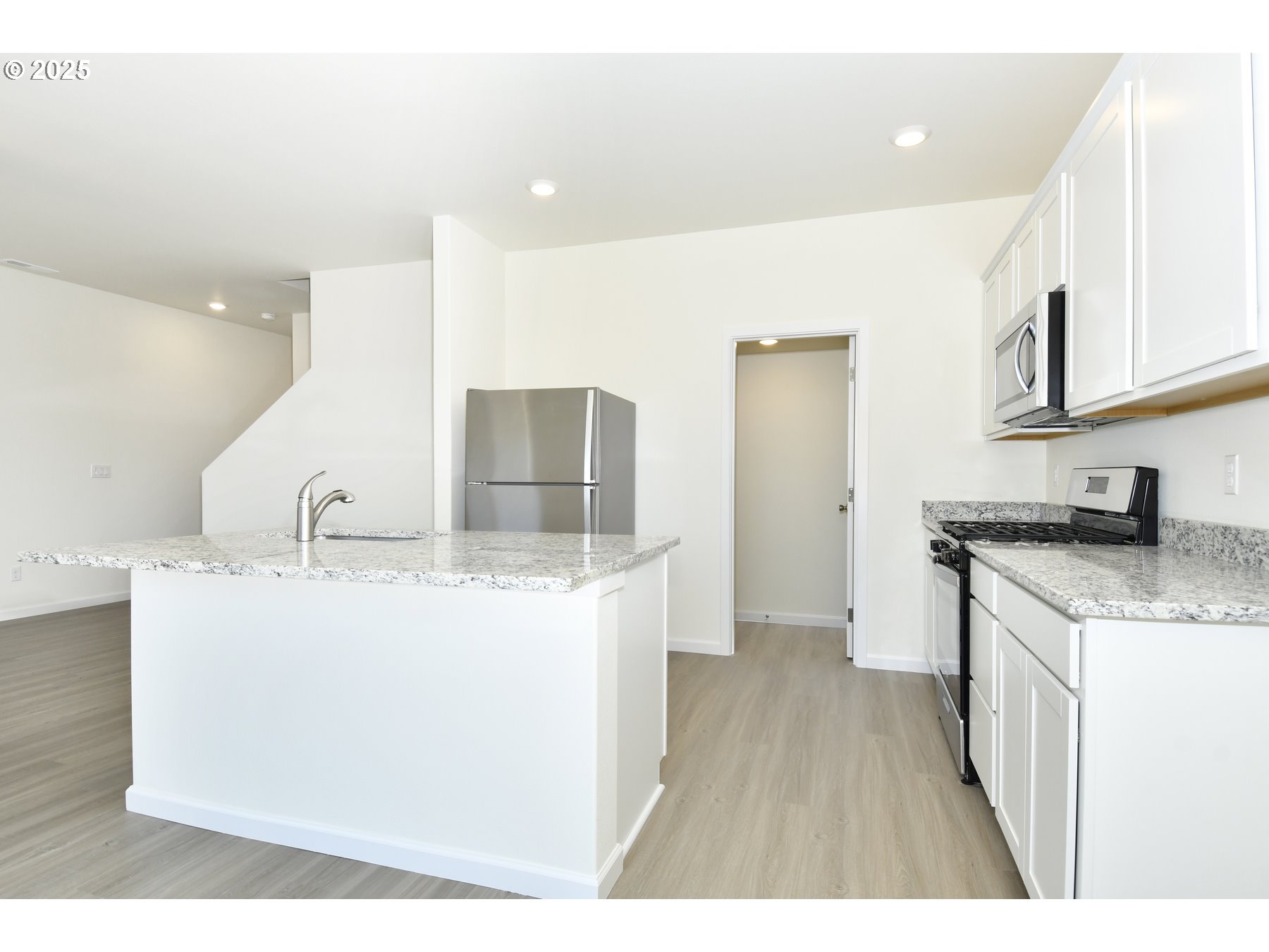 3915 Southwest Duniway Lane Gresham, OR 97080 - Photo 10 of 20 a kitchen with sink a refrigerator and wooden cabinets