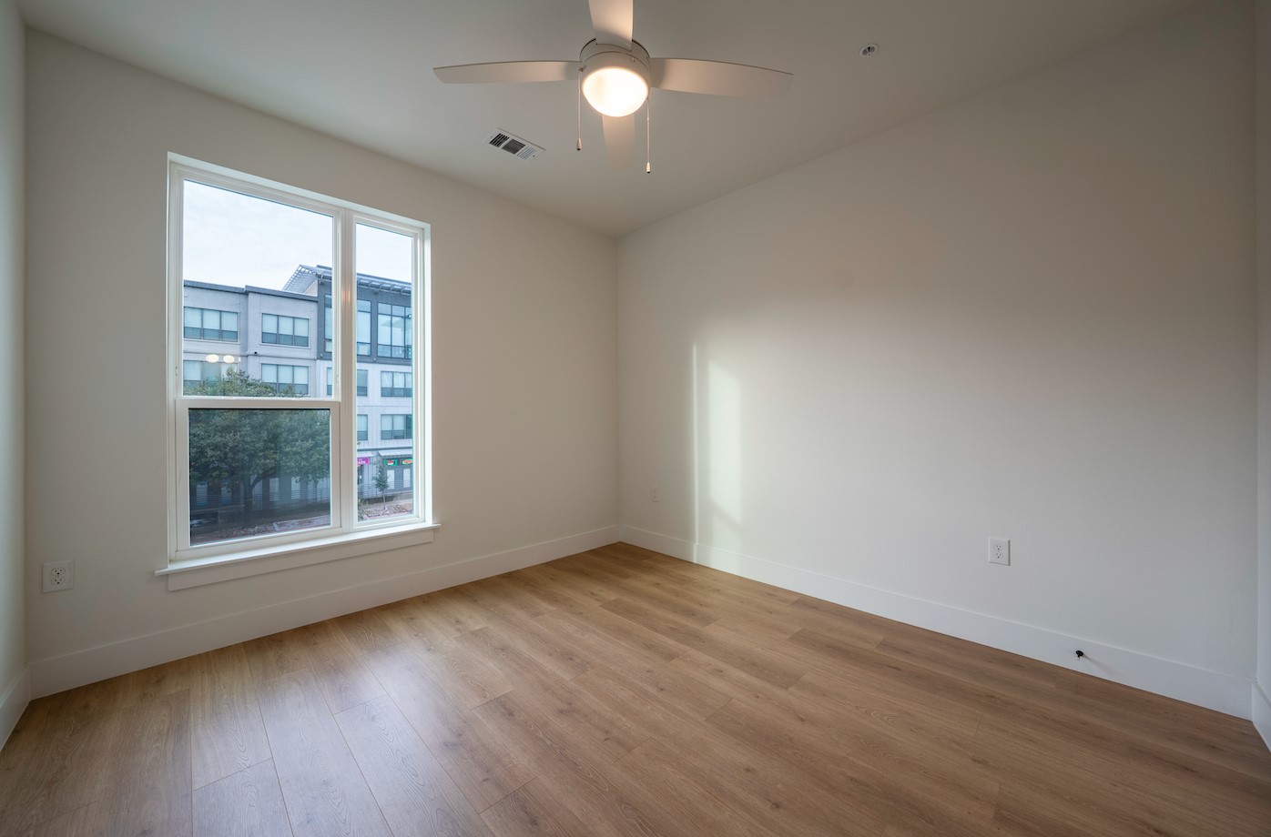 1701 Simond Avenue, Unit 212 Austin, TX 78723 - Photo 12 of 28 Spare room with light wood-style flooring and a ceiling fan