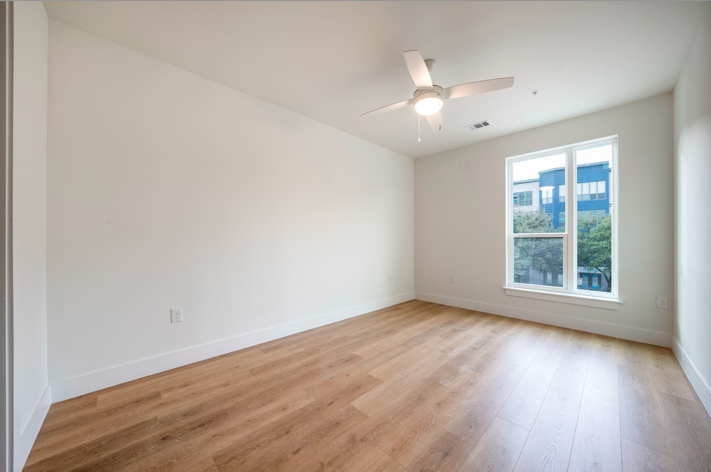 1701 Simond Avenue, Unit 212 Austin, TX 78723 - Photo 13 of 28 Empty room featuring light wood finished floors and a ceiling fan