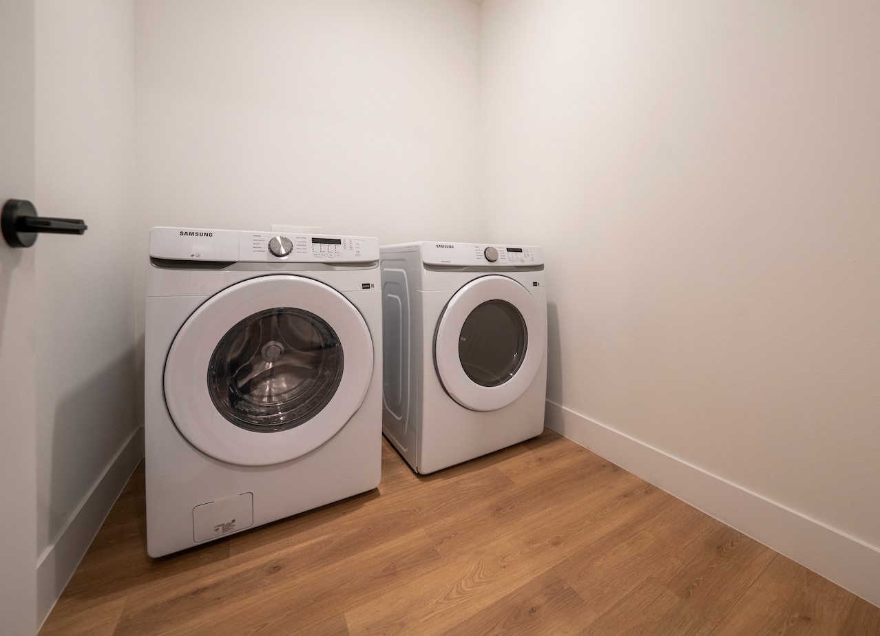 1701 Simond Avenue, Unit 212 Austin, TX 78723 - Photo 15 of 28 Laundry room featuring light wood-type flooring and washing machine and clothes dryer