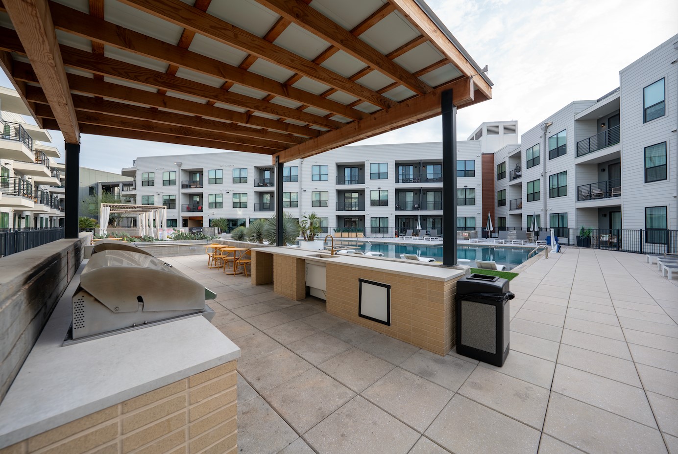 1701 Simond Avenue, Unit 212 Austin, TX 78723 - Photo 23 of 28 View of patio featuring a community pool and exterior kitchen