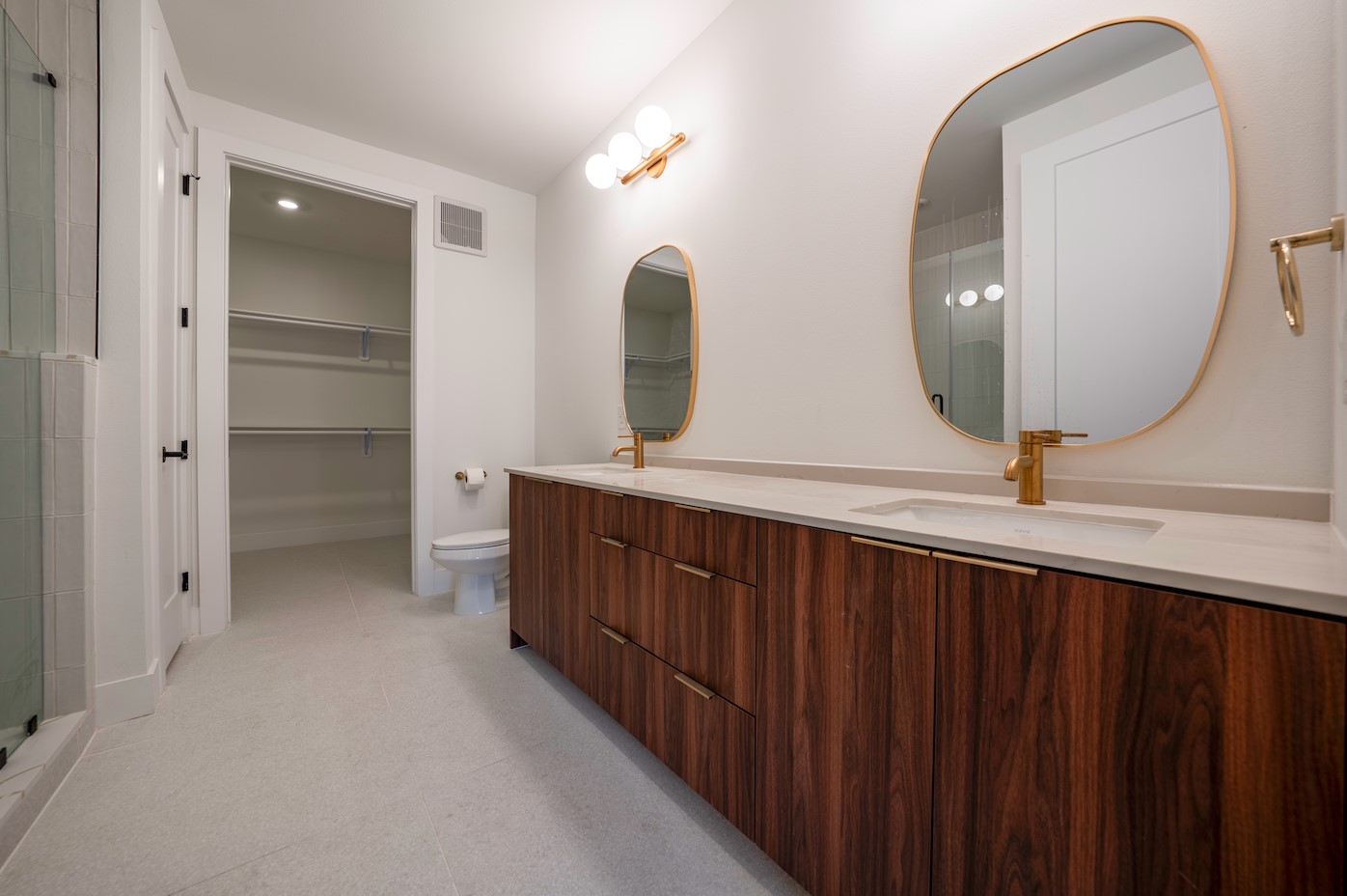 1701 Simond Avenue, Unit 212 Austin, TX 78723 - Photo 8 of 28 Full bath featuring double vanity, a walk in closet, and a shower with door