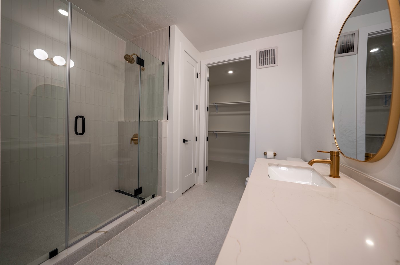1701 Simond Avenue, Unit 212 Austin, TX 78723 - Photo 10 of 28 Bathroom featuring a walk in closet, vanity, and a shower stall