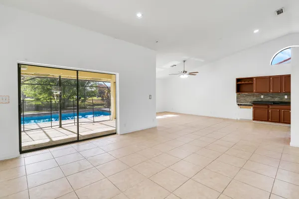 a view of an empty room with a fireplace and a flat screen tv