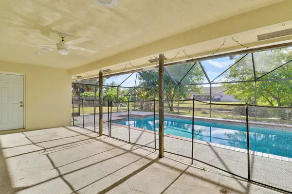 a bedroom with a bed and glass door