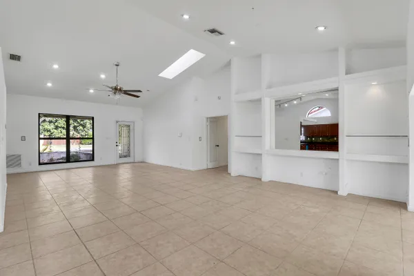 an empty room with a empty space and windows