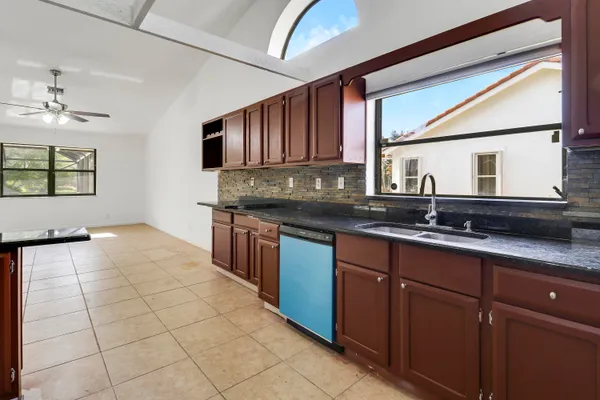 a kitchen with stainless steel appliances granite countertop a sink stove and cabinets