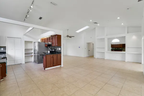 a large kitchen with a refrigerator and a stove
