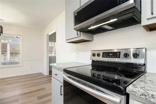 a stove top oven sitting inside of a kitchen