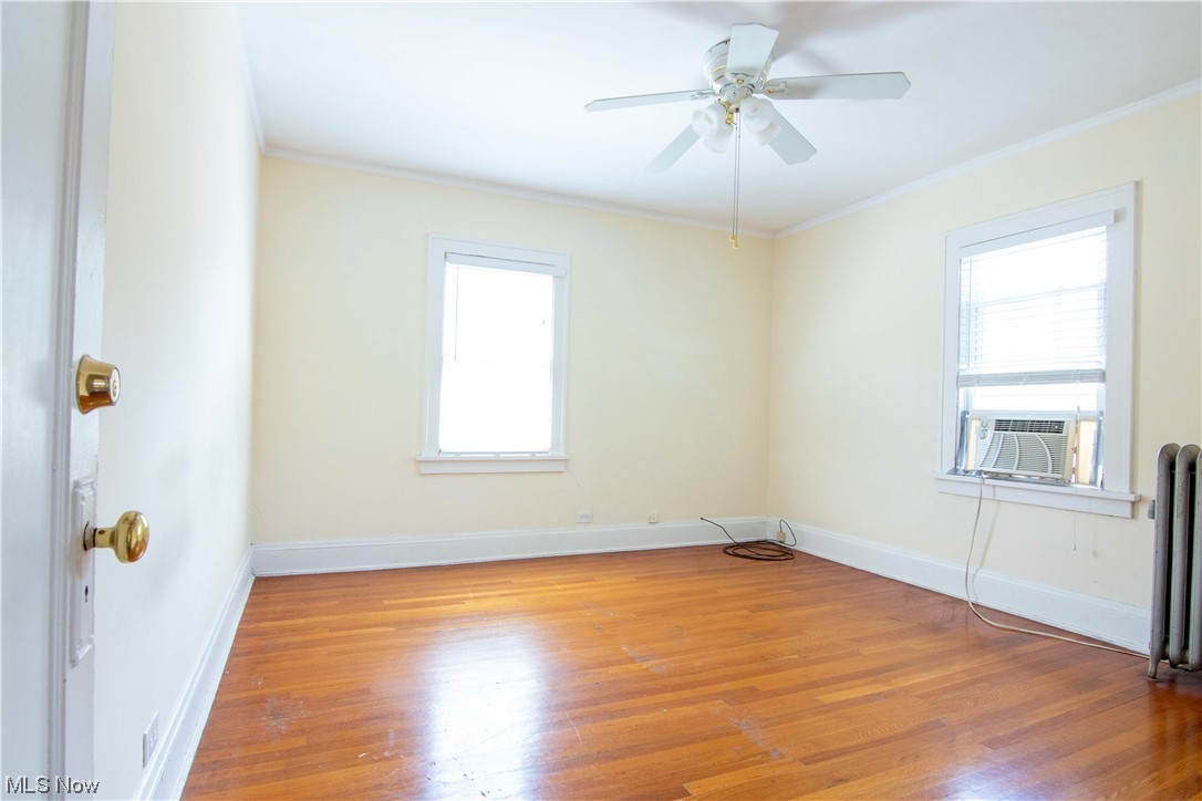 2261 Maplewood Road Cleveland, OH 44118 - Photo 30 of 44 Unfurnished room featuring plenty of natural light, light hardwood / wood-style floors, crown molding, and ceiling fan