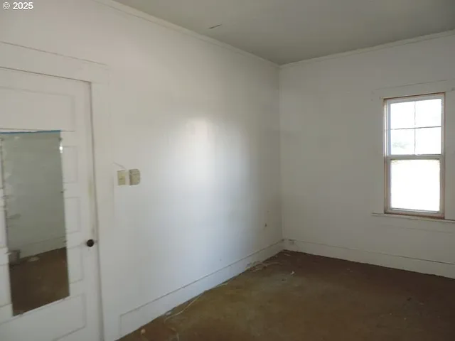 a view of a room with wooden floor and windows