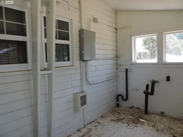 a backyard of a house with table and chairs