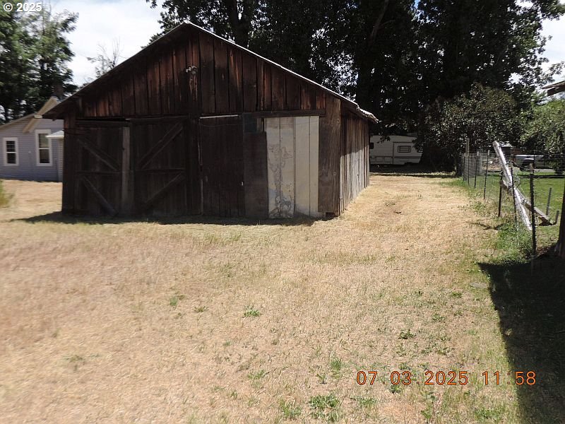 314 Northwest 2nd Street Grass Valley, OR 97029 - Photo 26 of 26 a view of backyard with wooden fence