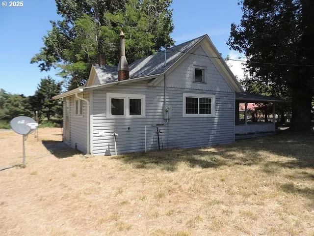 a view of a house with a yard covered in snow