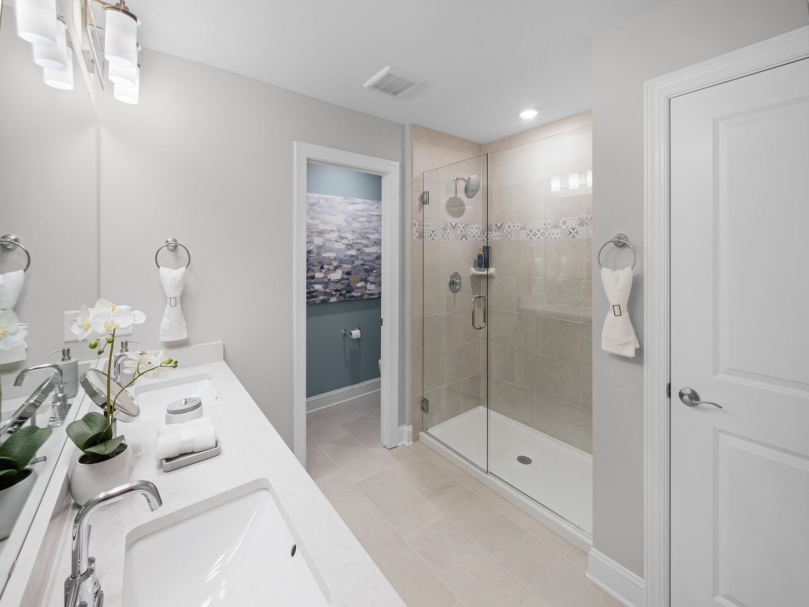 8305 Aldous Way Raleigh, NC 27616 - Photo 8 of 16 a bathroom with a shower sink and mirror