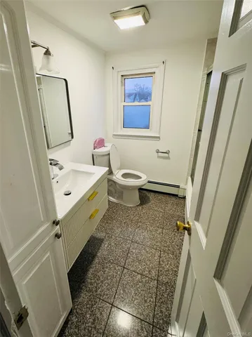 a bathroom with a sink a toilet and a mirror