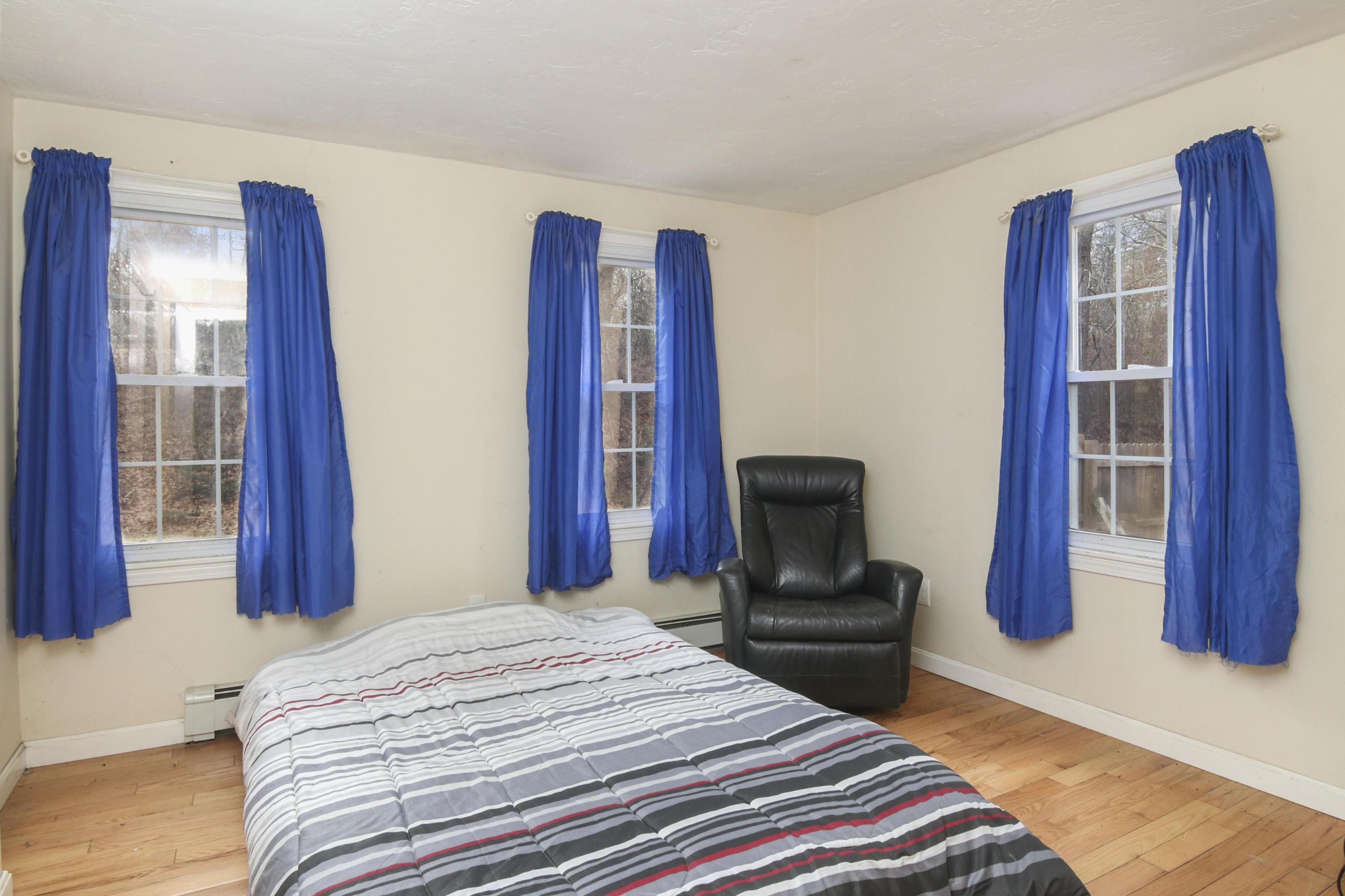 45 Blackthorn Path Forestdale, MA 02644 - Photo 14 of 19 a bedroom with a bed and dresser with wooden floor