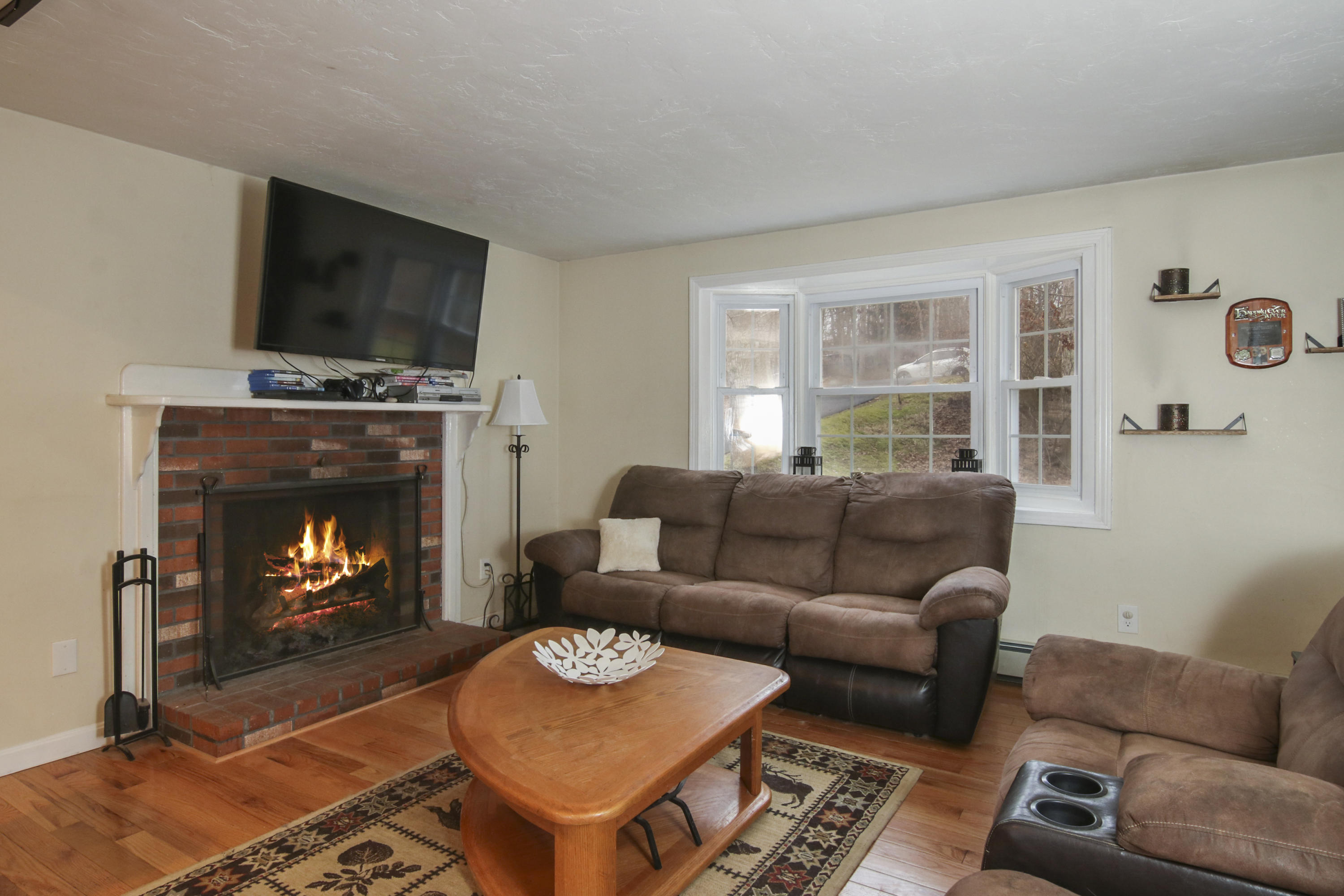 45 Blackthorn Path Forestdale, MA 02644 - Photo 6 of 19 a living room with furniture a flat screen tv and a fireplace