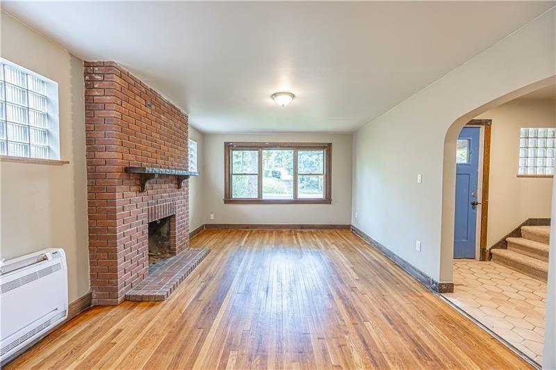 9502 Frankstown Road Penn Hills, PA 15235 - Photo 3 of 24 Nice living room with fireplace, hardwood floors, newer windows, and a very large room.