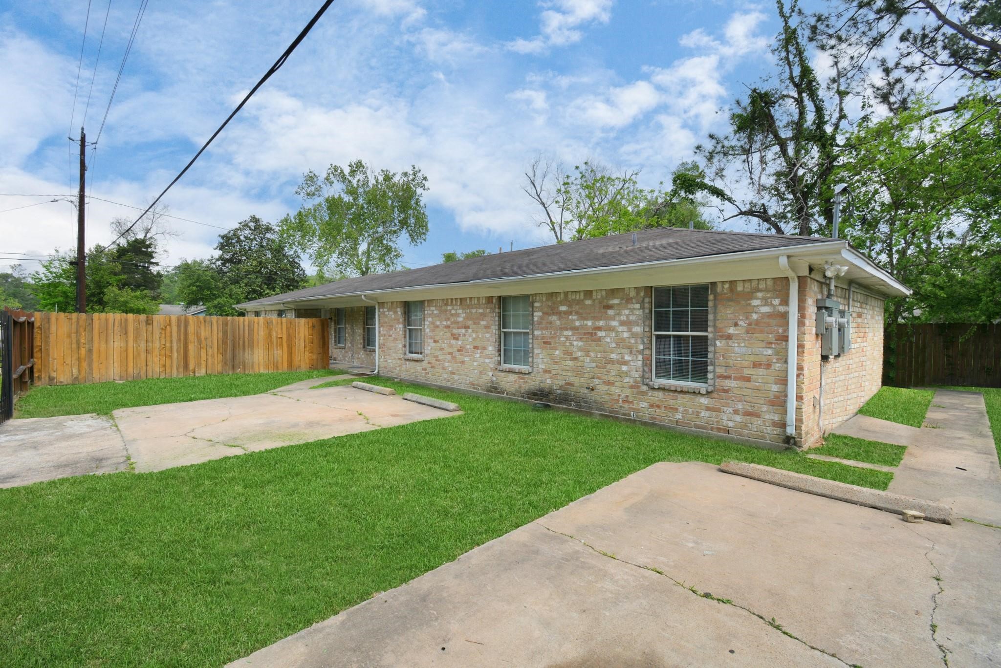 8622 Elbert Street, Unit B Houston, TX 77028 - Photo 1 of 21 a front view of a house with a yard and garage