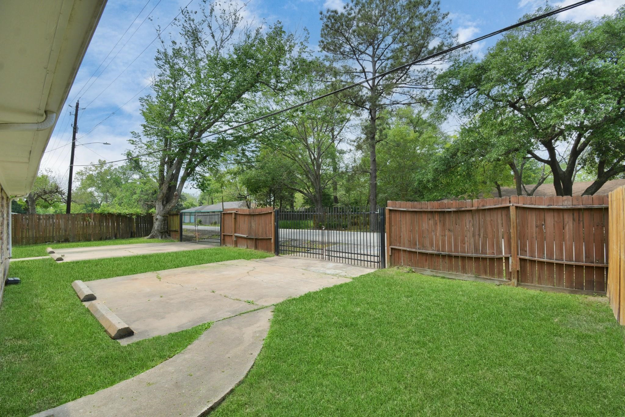 8622 Elbert Street, Unit B Houston, TX 77028 - Photo 16 of 21 a view of a backyard with a small cabin and wooden fence