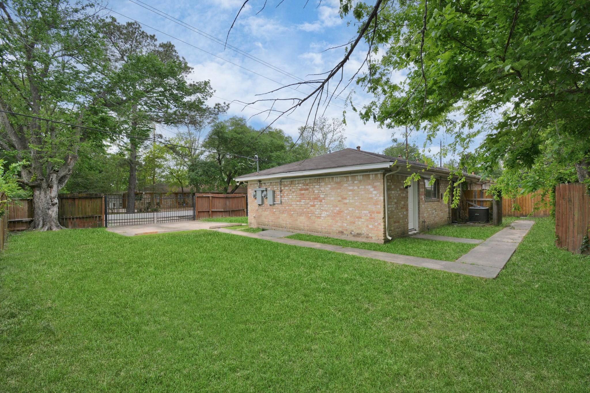 8622 Elbert Street, Unit B Houston, TX 77028 - Photo 17 of 21 a view of a backyard with large trees