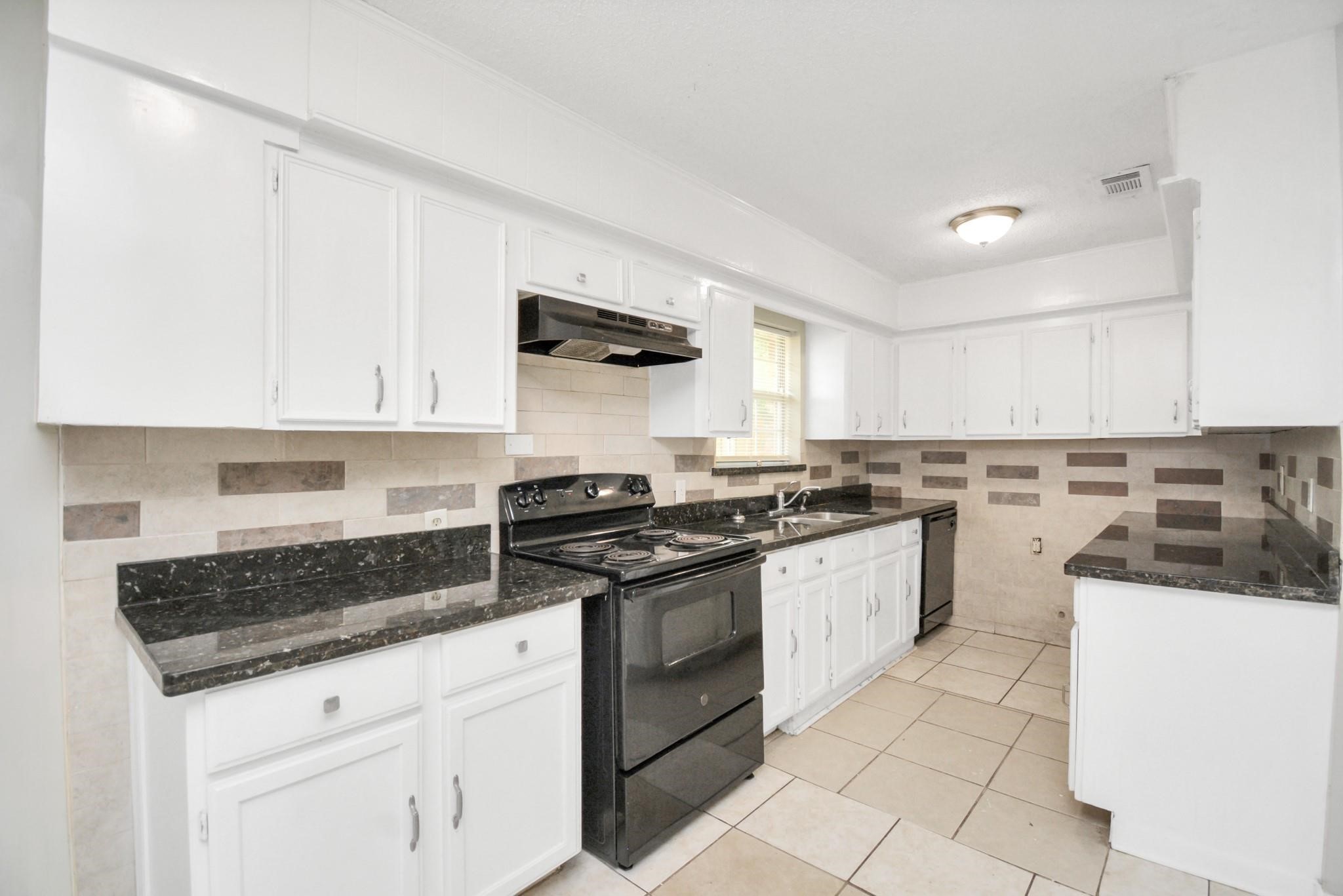 8622 Elbert Street, Unit B Houston, TX 77028 - Photo 6 of 21 a kitchen with cabinets appliances and a counter top space