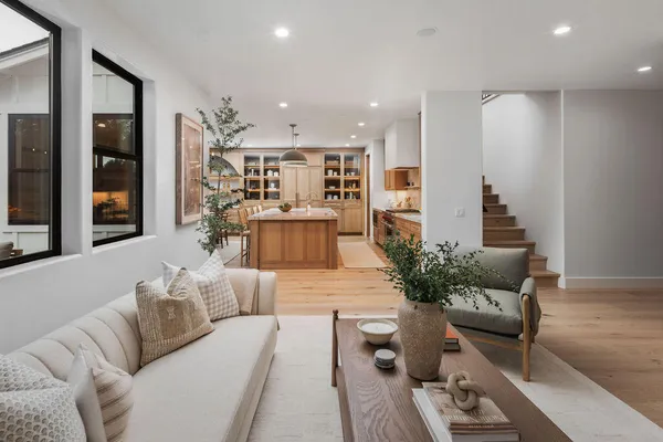 a living room with furniture and flowers