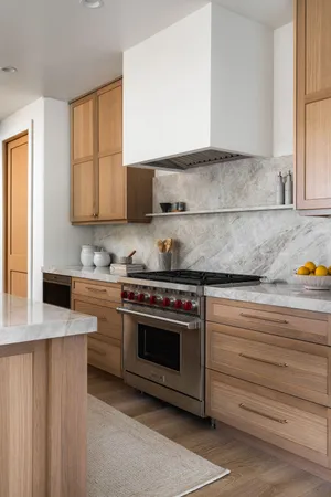 a kitchen with granite countertop a stove a sink and a microwave