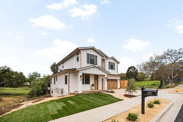 a front view of a house with garden