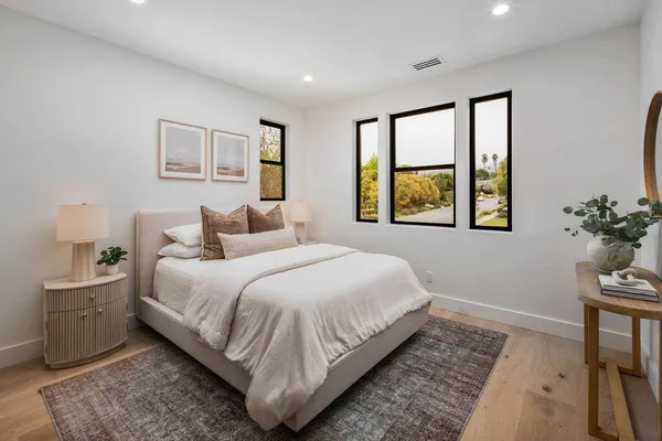 a bedroom with a large bed and a window