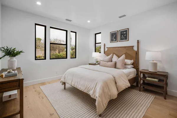 a bedroom with a large bed and a window