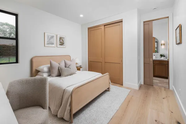 a spacious bedroom with a bed and a window