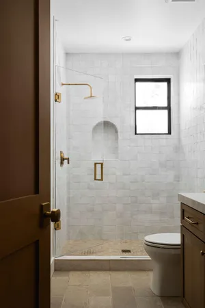 a bathroom with a toilet and a shower