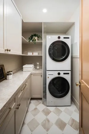 a utility room with sink dryer and washer