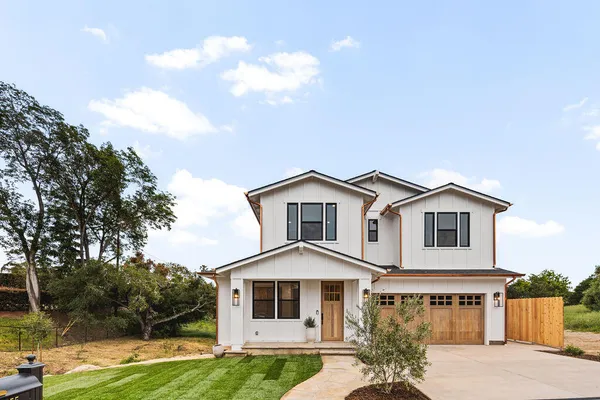 a front view of a house with garden