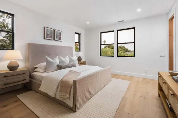 a bedroom with a large bed and a window