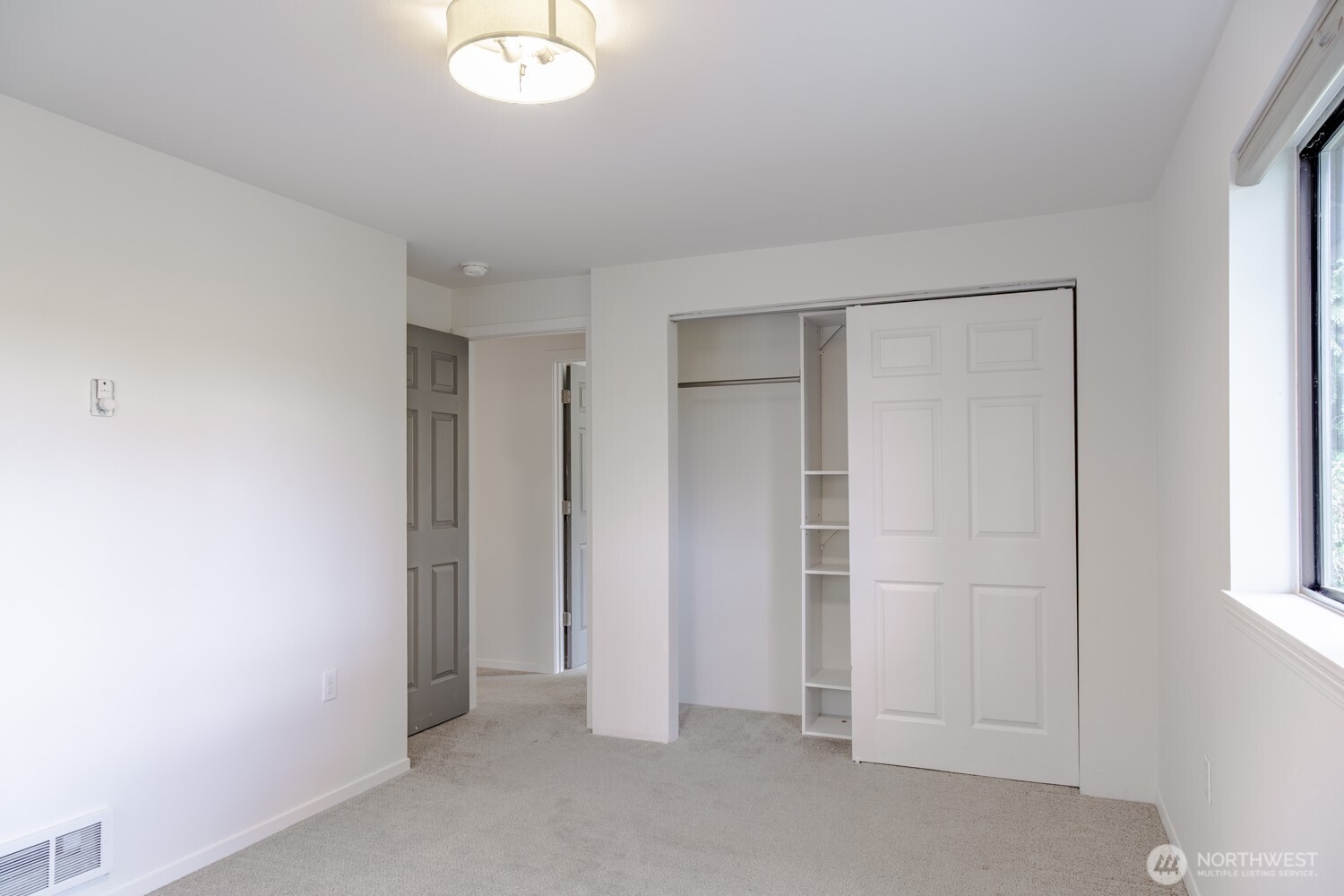 912 Northeast 115th Street Seattle, WA 98125 - Photo 19 of 21 an empty room with windows and closet