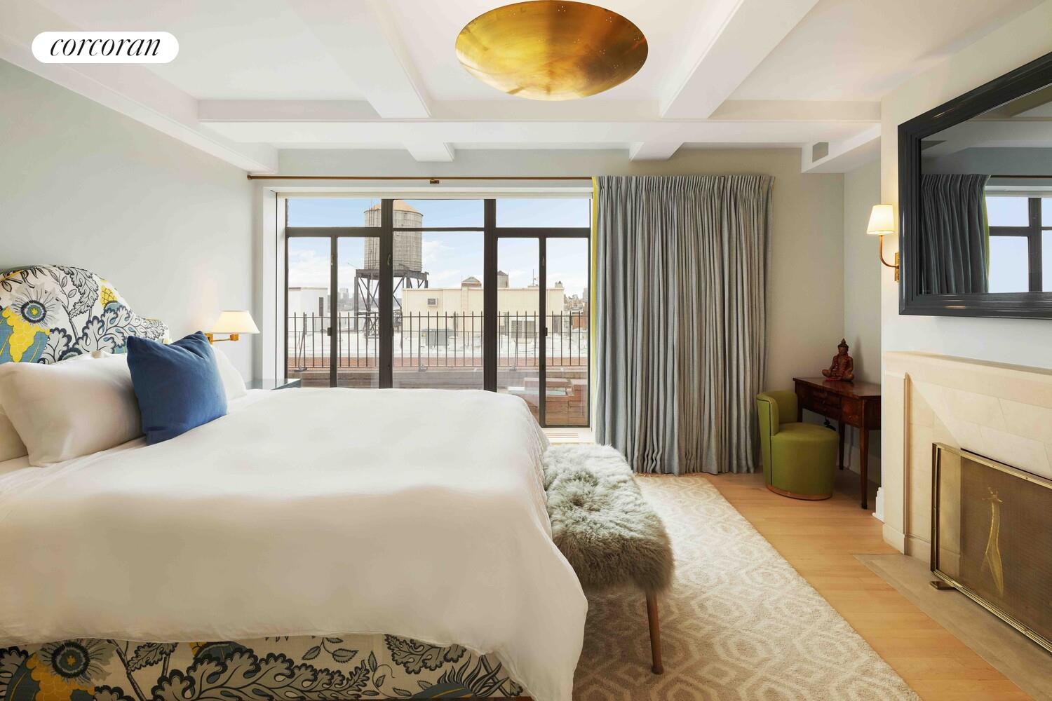 140 Riverside Drive, Unit 19HO Manhattan, NY 10024 - Photo 30 of 35 a bedroom with a bed and a large window