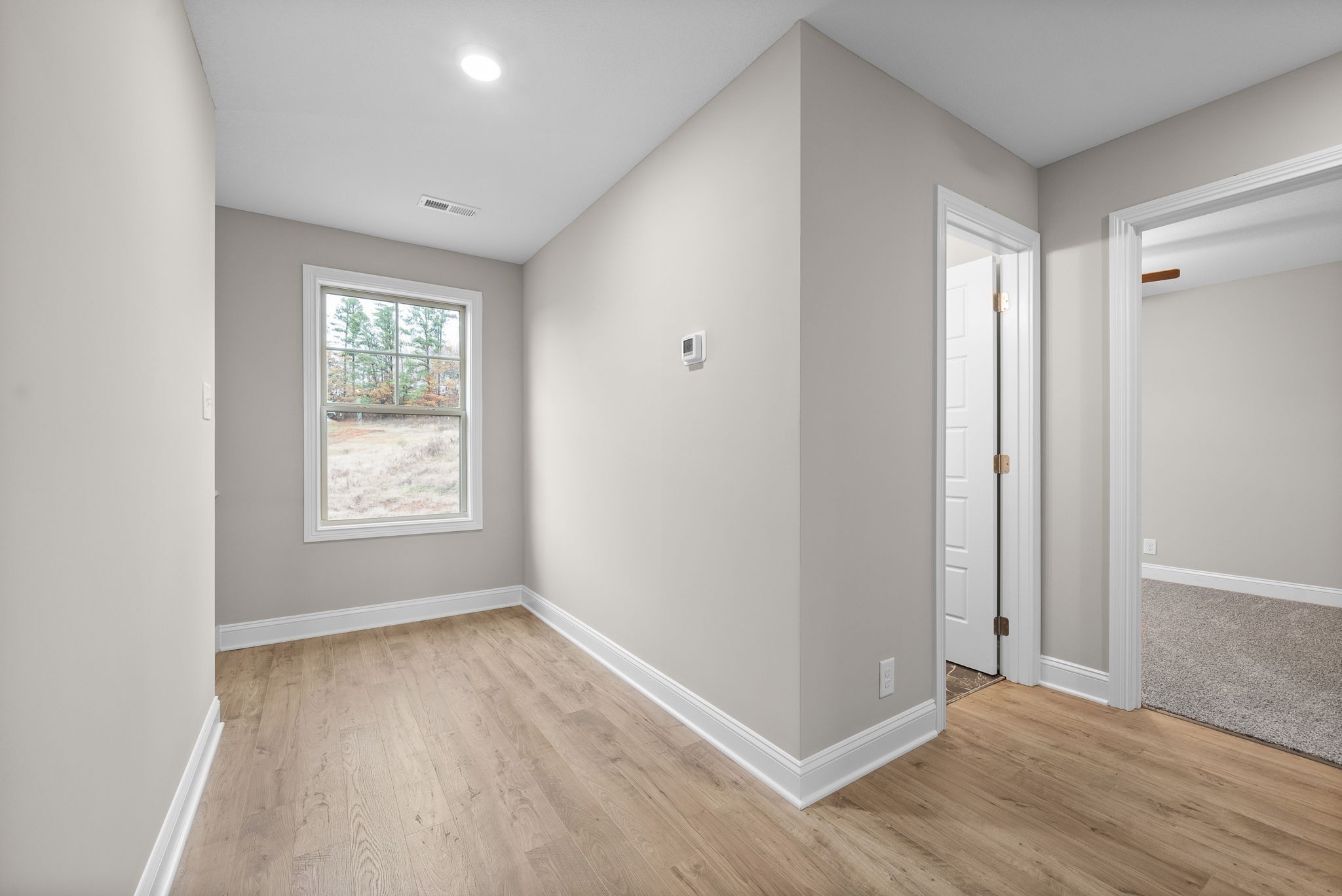 4 Echo Ridge Oak Grove, KY 42262 - Photo 12 of 29 an empty room with wooden floor and windows