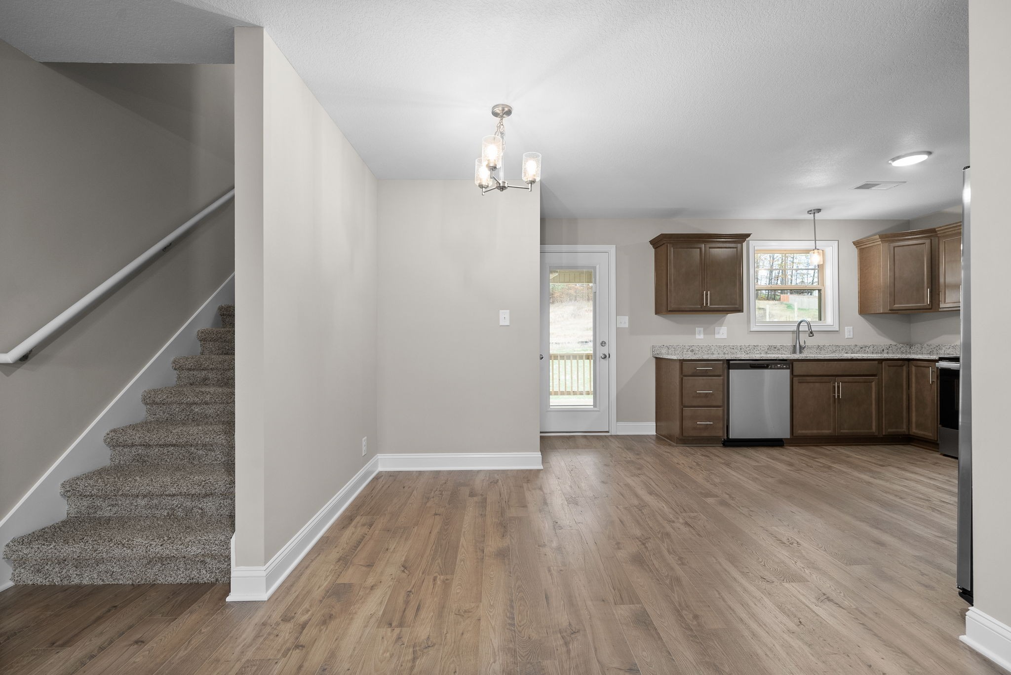 4 Echo Ridge Oak Grove, KY 42262 - Photo 6 of 29 a view of a kitchen with a sink wooden cabinet and a living room