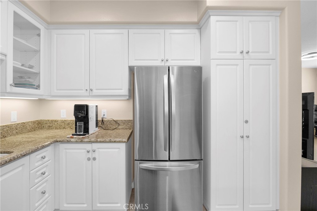 10 Agave Court Ladera Ranch, CA 92694 - Photo 14 of 36 a kitchen with granite countertop a refrigerator sink and cabinets